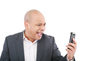 Angry business man screaming on cell mobile phone